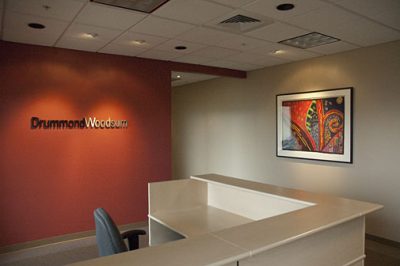 Reception area with red and beige walls and modern decor.