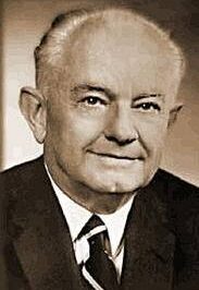 Portrait of a distinguished older man in a suit and tie.