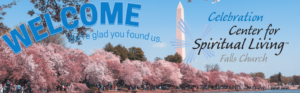 Welcome sign with cherry blossoms and monument.