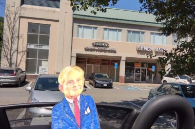 paper doll in front of building with tienda anita shop
