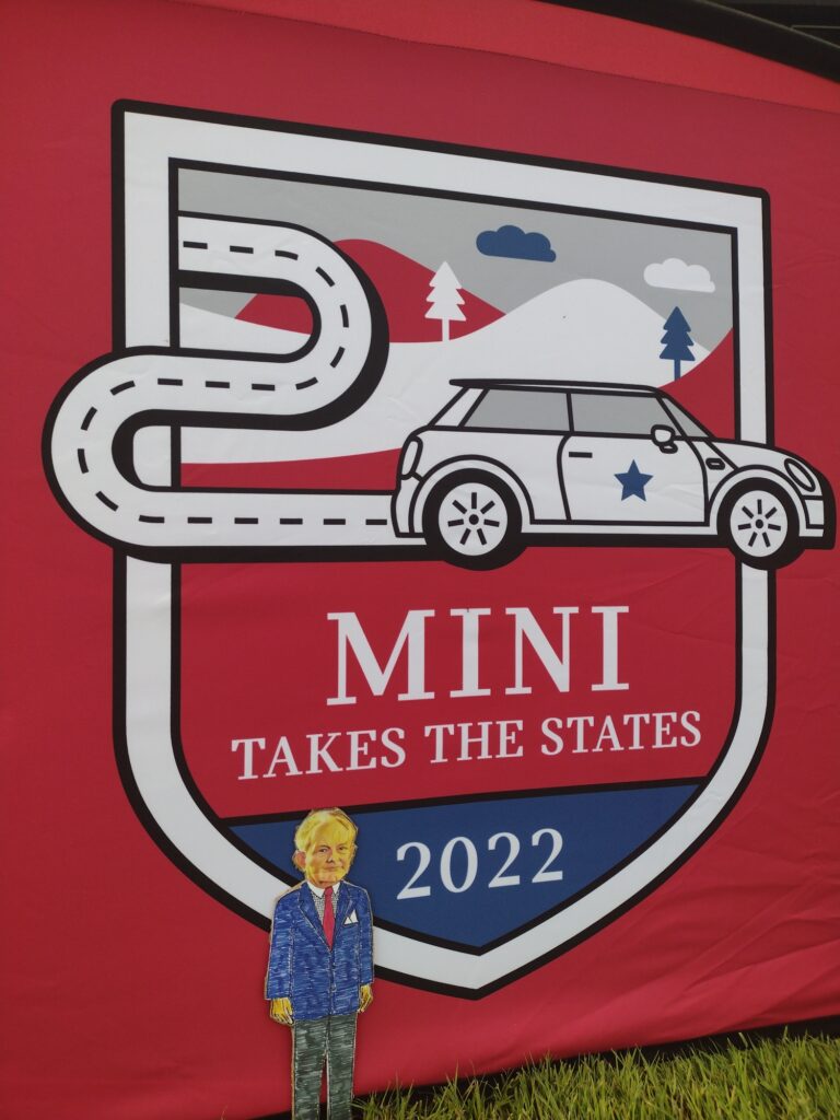 paper doll in front of tarp that says mini takes the states