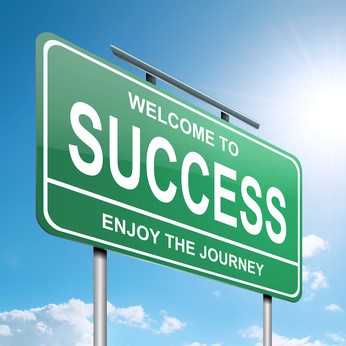 Green road sign saying 'Welcome to Success, Enjoy the Journey'.