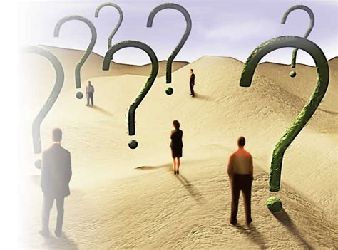 People walking on a sandy path surrounded by large question marks.