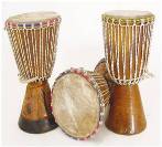 Two wooden djembes and a small drum with animal skin heads.