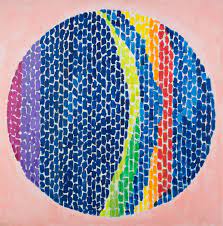 Colorful circular mosaic with vibrant stripes and patterns.