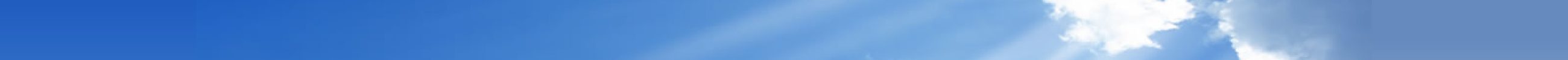 Clear blue sky with soft white clouds and sun rays.