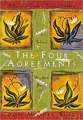 Cover of The Four Agreements book with floral artwork and text.
