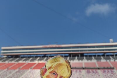 paper doll in bleachers with blue sky