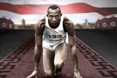 Athlete ready to sprint on a track with a determined expression.