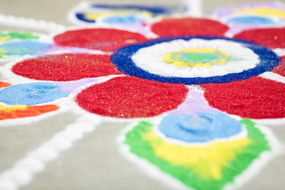 Close-up of colorful rangoli art with vibrant powders.