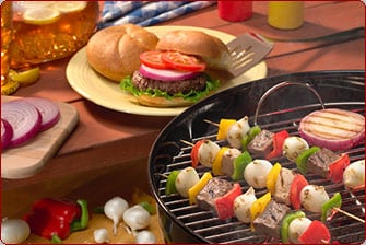 picnic table with kebabs and burger